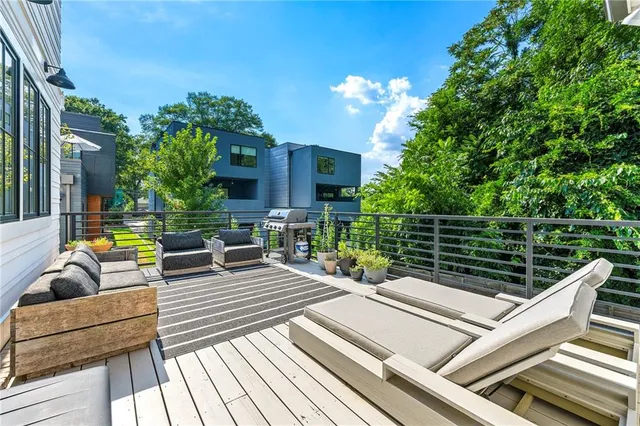 a view of a roof deck with couches and potted plants