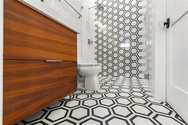 a bathroom with a toilet and a shower curtain