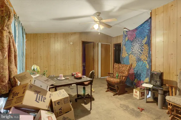 a view of a livingroom with furniture and a window