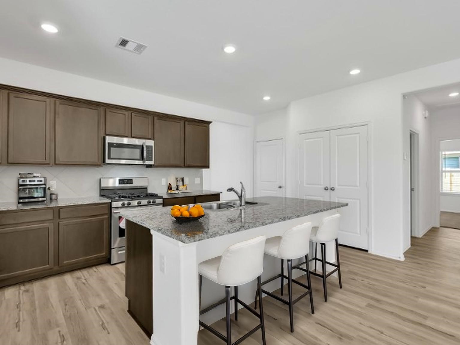 3806 Rock Ledge Drive Rosenberg, TX 77469 - Photo 3 of 23 kitchen with large island, stylish cabinetry, and plenty of prep space