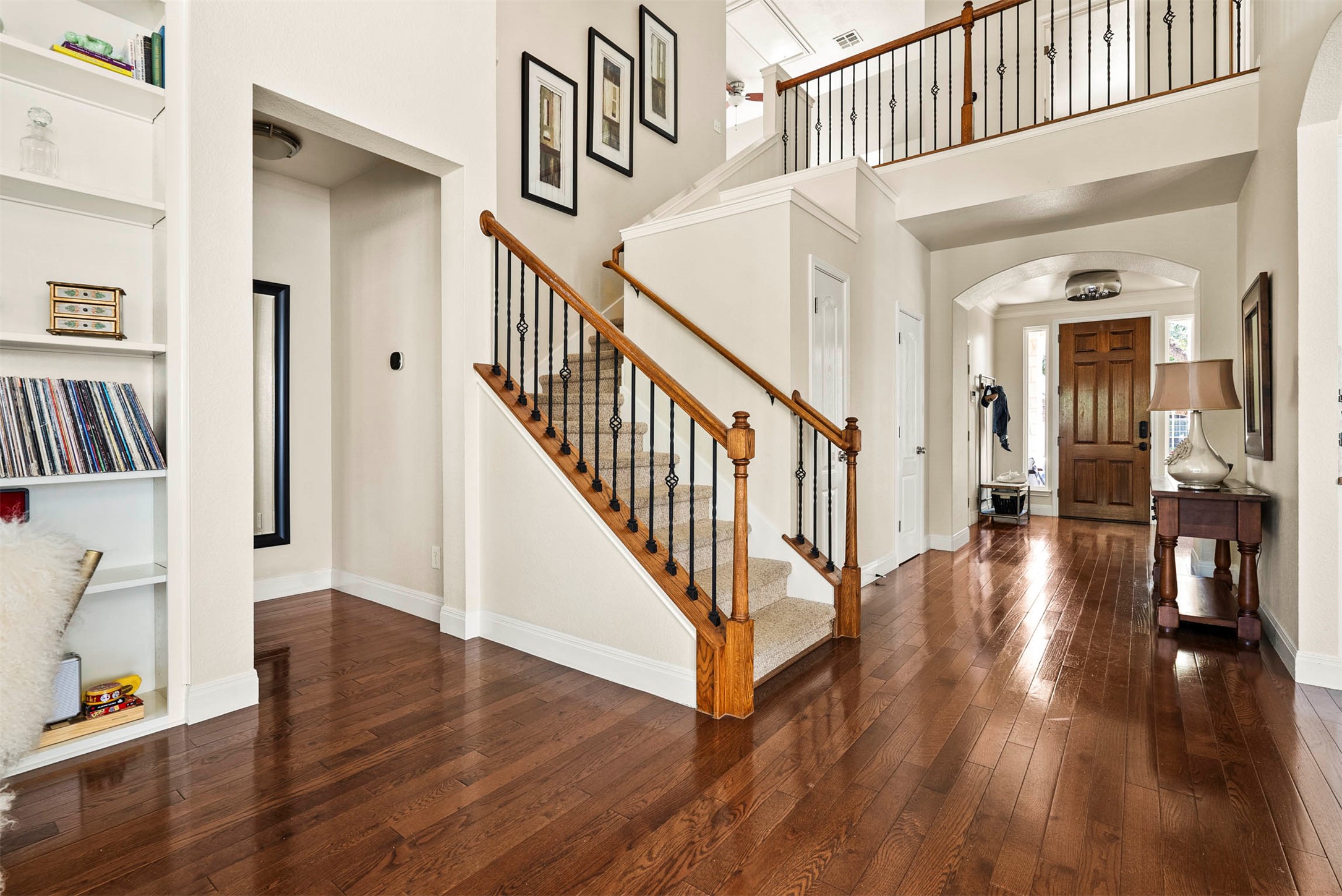 6720 Hansa Loop Austin, TX 78739 - Photo 12 of 38 This view from the living room highlights the transition to the foyer and the staircase leading to the second-floor game room