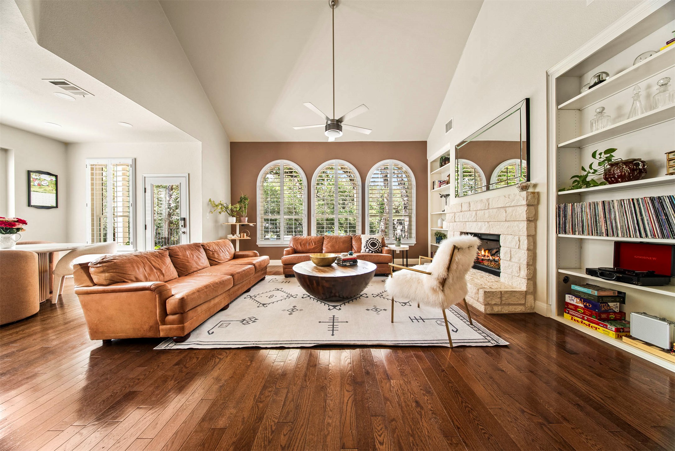 6720 Hansa Loop Austin, TX 78739 - Photo 13 of 38 The two-story ceilings and wall of arched windows create a grand yet comfortable atmosphere in the main living space