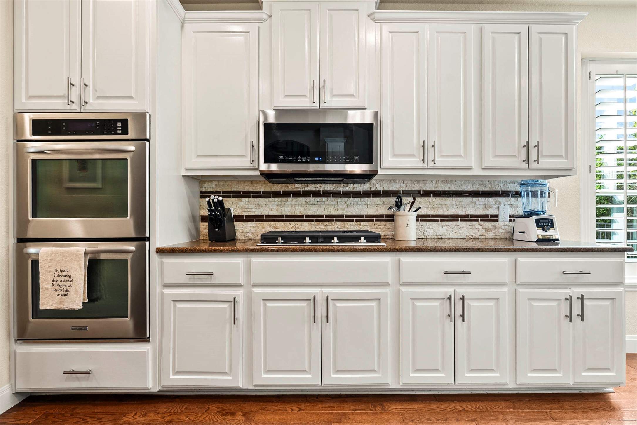 6720 Hansa Loop Austin, TX 78739 - Photo 17 of 38 Equipped with stainless steel appliances, including a gas cooktop and built-in double ovens for effortless hosting