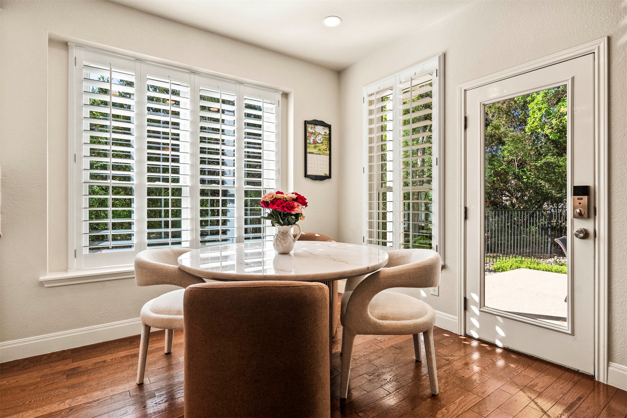6720 Hansa Loop Austin, TX 78739 - Photo 19 of 38 The dining space sits right off the kitchen, looking out toward the backyard greenery through large windows.