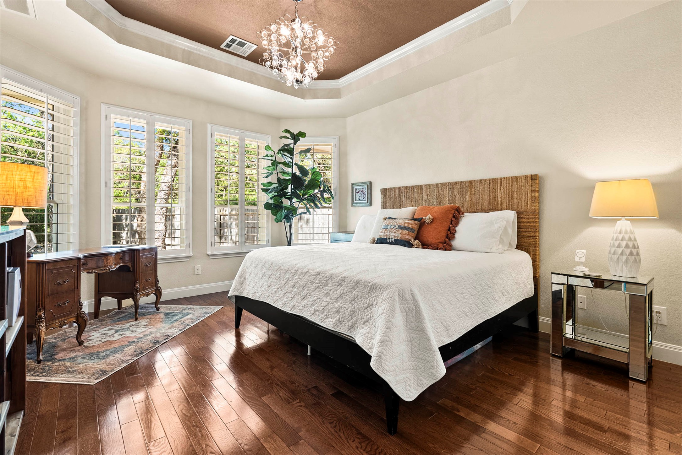 6720 Hansa Loop Austin, TX 78739 - Photo 20 of 38 The main-floor primary suite features a tray ceiling and large windows that overlook the private backyard