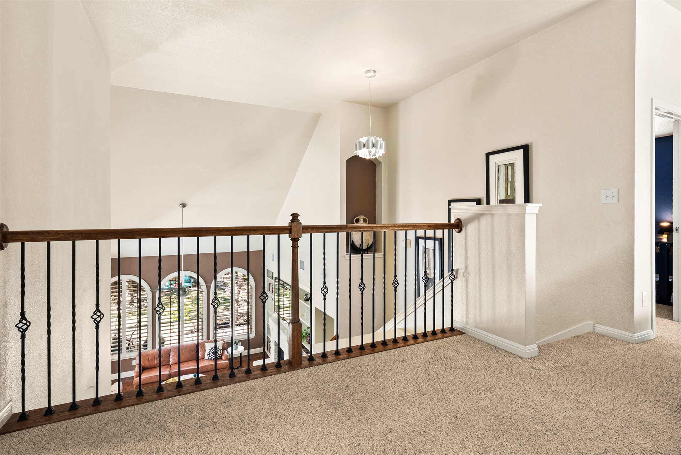 6720 Hansa Loop Austin, TX 78739 - Photo 25 of 38 This vantage point from the second floor highlights the impressive two-story architecture and the way light fills the main living area below