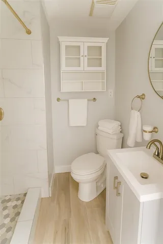 a white toilet sitting next to a bathroom sink