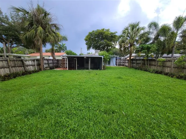 a view of a house with a yard and sitting area
