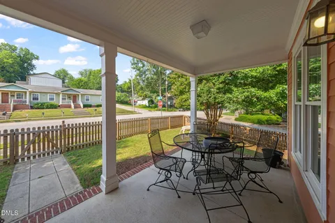 a view of a chairs and table in the patio and a backyard