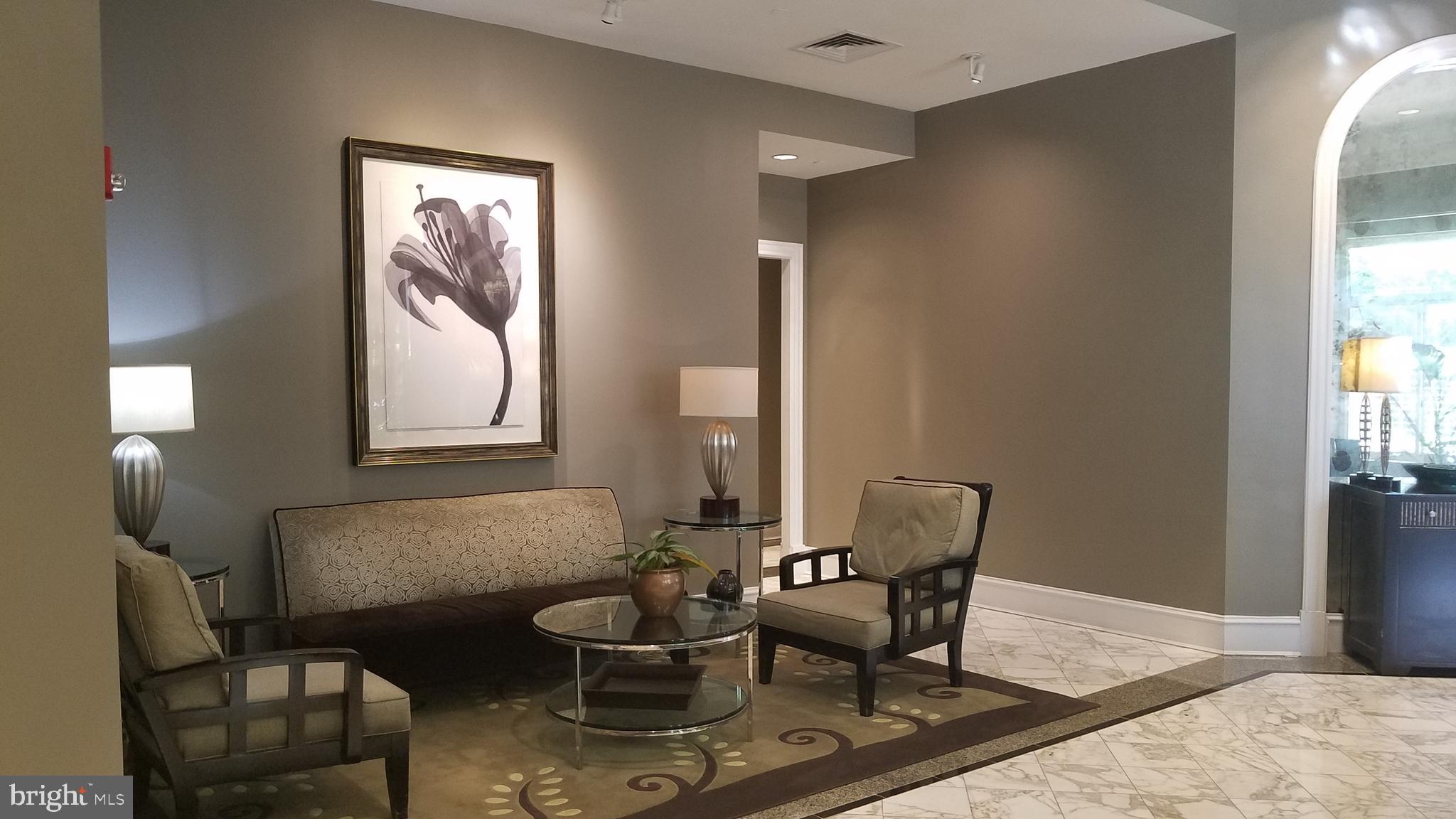 851 North Glebe Road, Unit 1015 Arlington, VA 22203 - Photo 20 of 29 a living room with furniture and a window