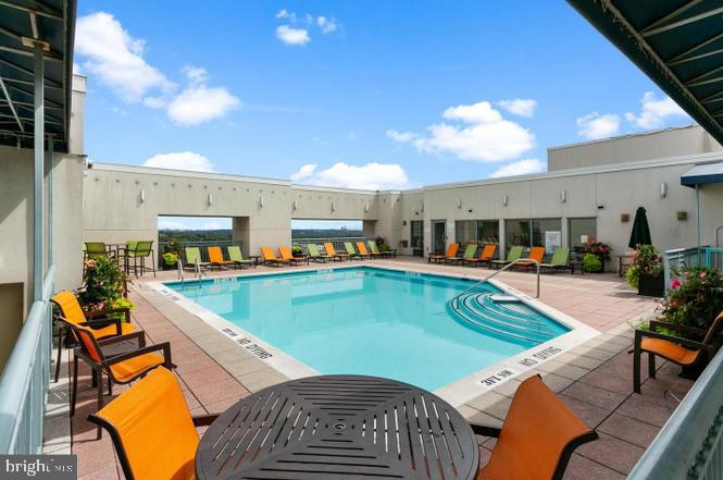 851 North Glebe Road, Unit 1015 Arlington, VA 22203 - Photo 22 of 29 a view of a swimming pool with outdoor seating