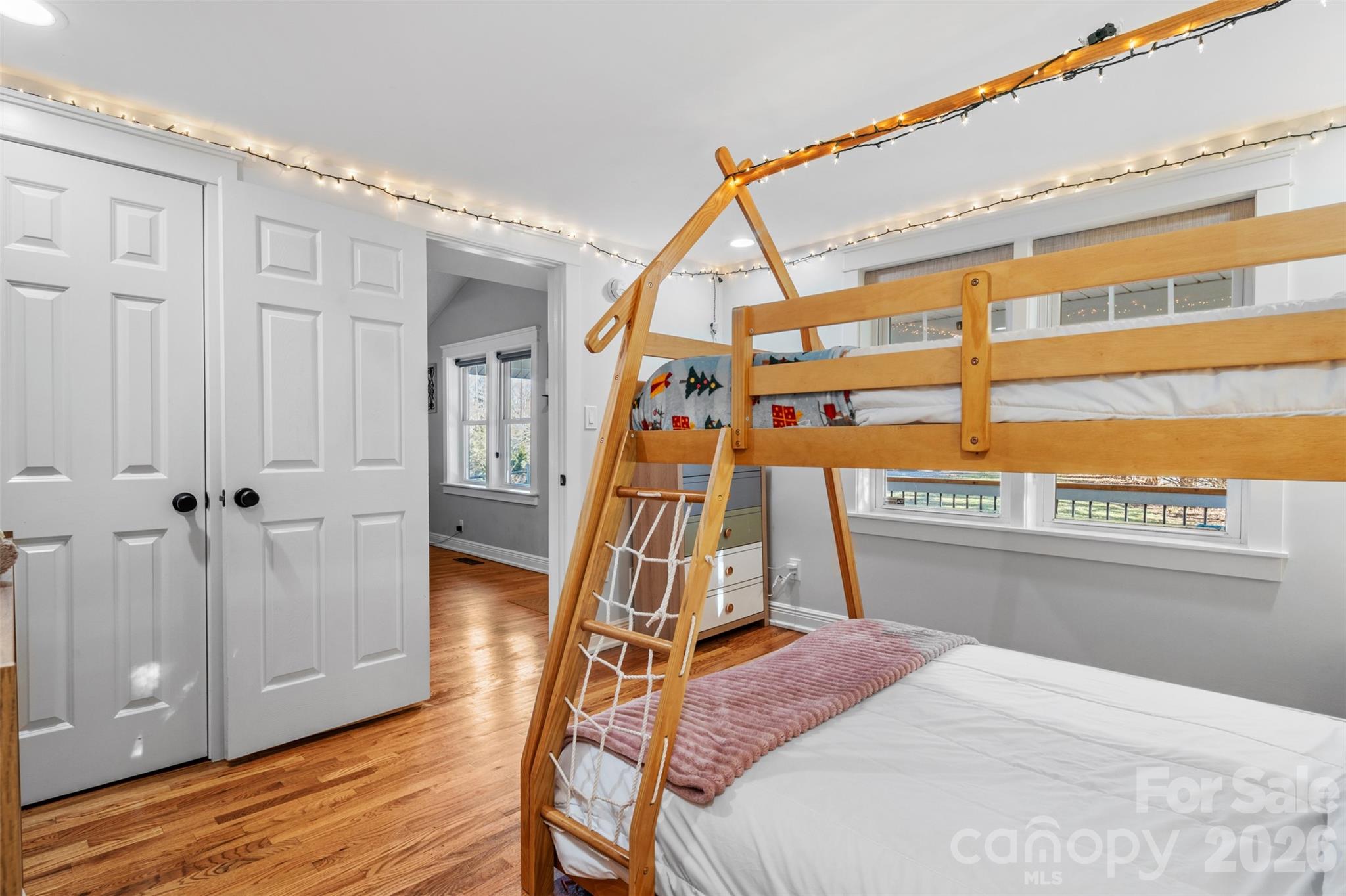 32 Youngs Cove Road Candler, NC 28715 - Photo 22 of 35 a bedroom with a bed and wooden floor