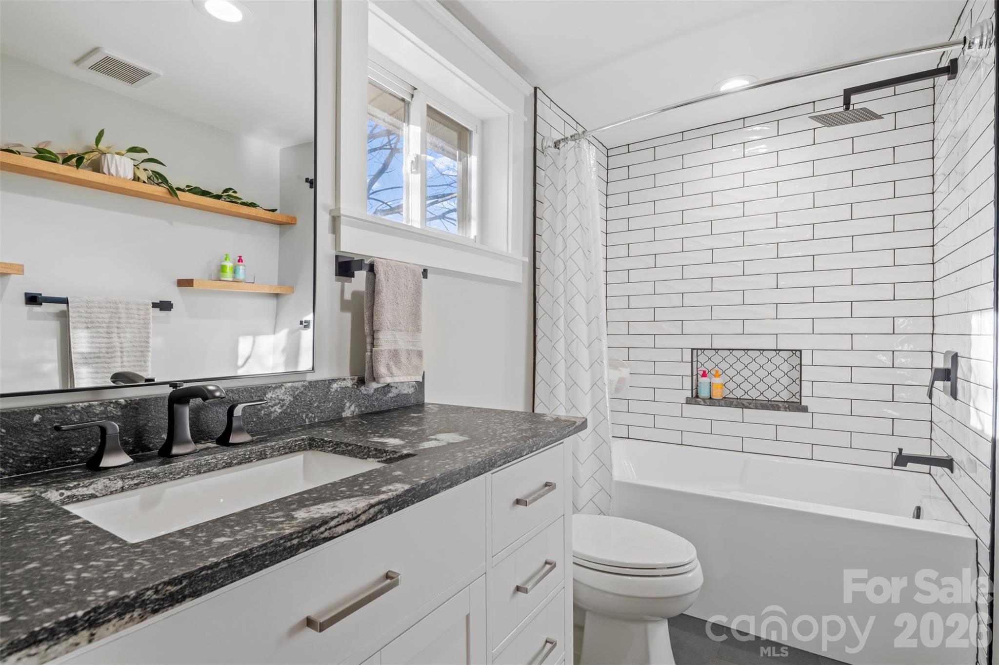 32 Youngs Cove Road Candler, NC 28715 - Photo 23 of 35 a bathroom with a granite countertop sink toilet and shower