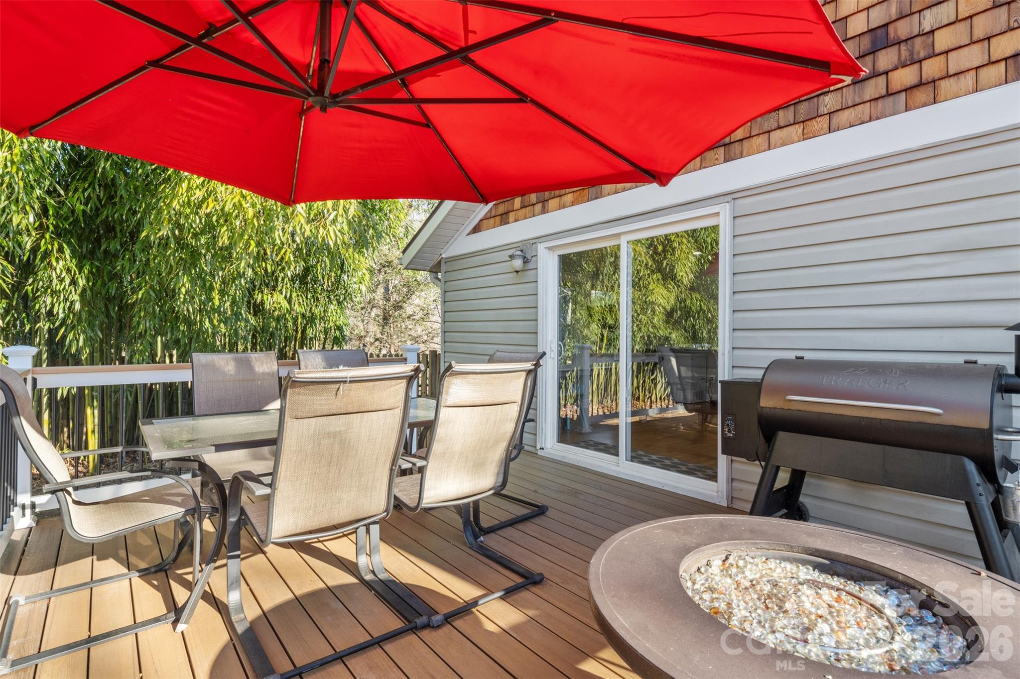 32 Youngs Cove Road Candler, NC 28715 - Photo 26 of 35 a view of a patio with a table and chairs under an umbrella