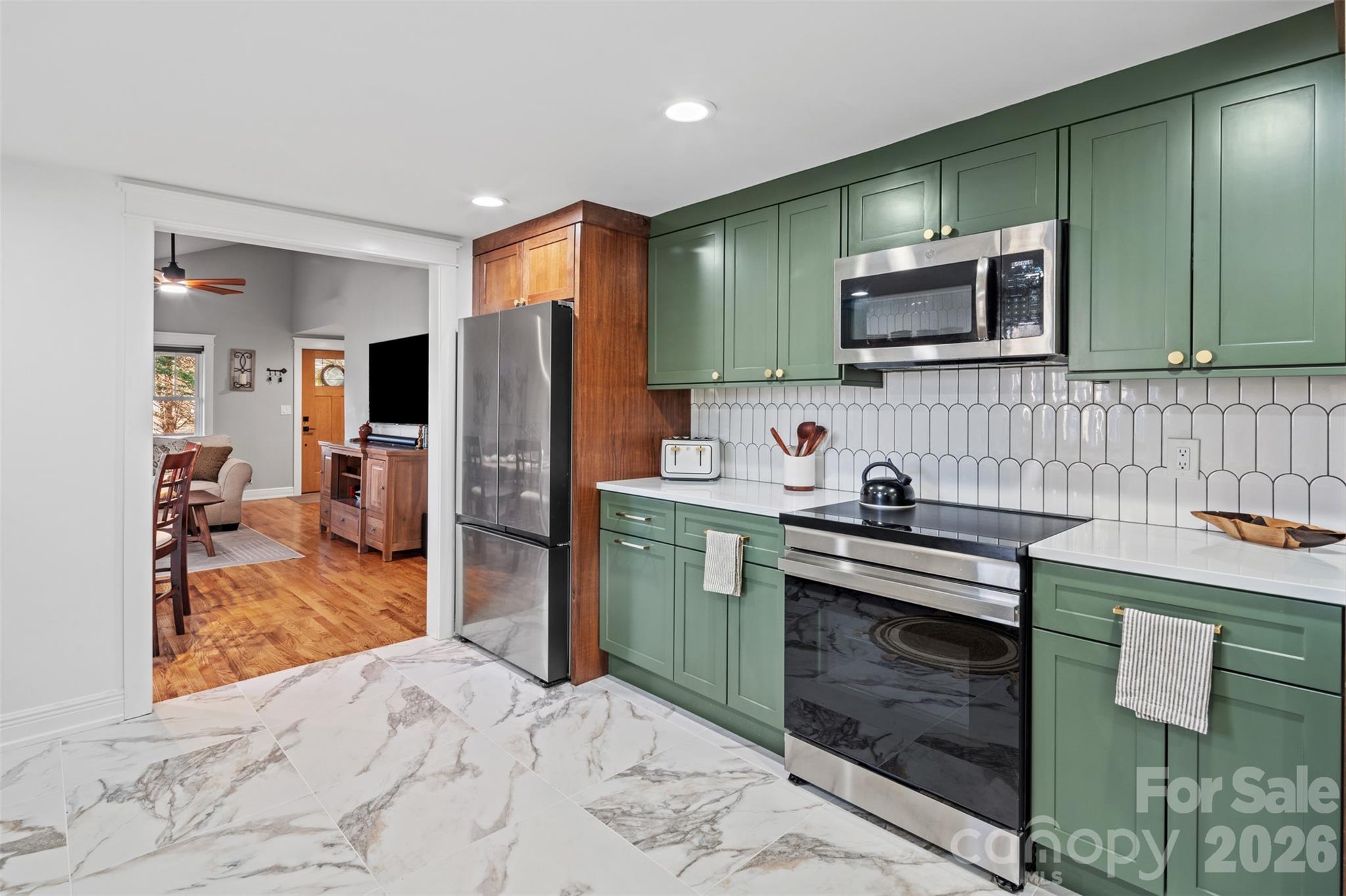 32 Youngs Cove Road Candler, NC 28715 - Photo 9 of 35 a kitchen with a sink stove and refrigerator