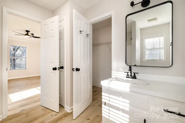a bathroom with a bathtub sink and mirror
