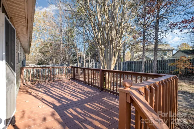 a view of balcony with wooden floor and fence