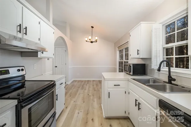 a kitchen with a sink stove and cabinets