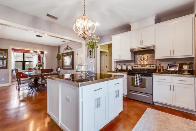 a view of a dining room with furniture wooden floor and chandelier