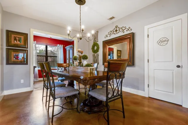 a kitchen with stainless steel appliances granite countertop a refrigerator a stove a sink dishwasher and white cabinets with wooden floor