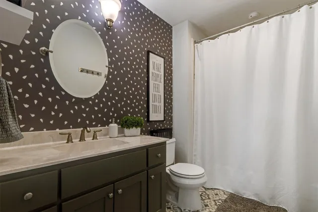 a spacious bedroom with a bed and a window