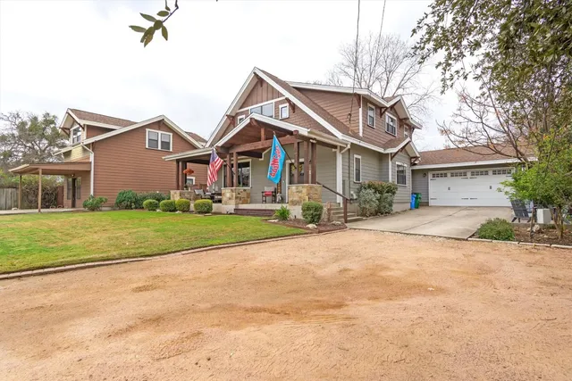 a front view of house with yard and green space