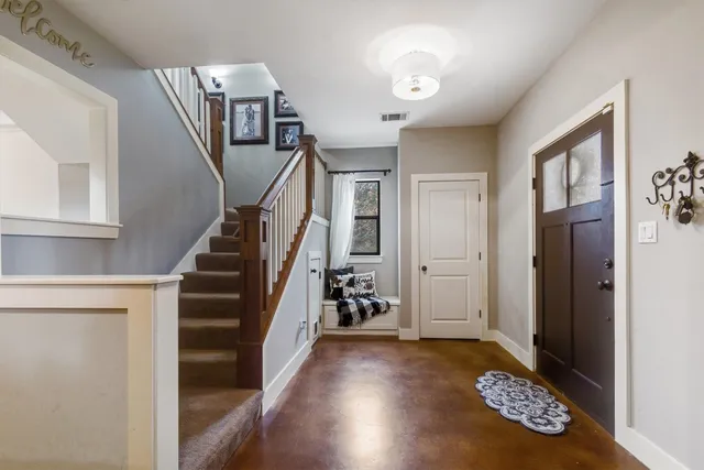 a view of entryway and hall with wooden floor