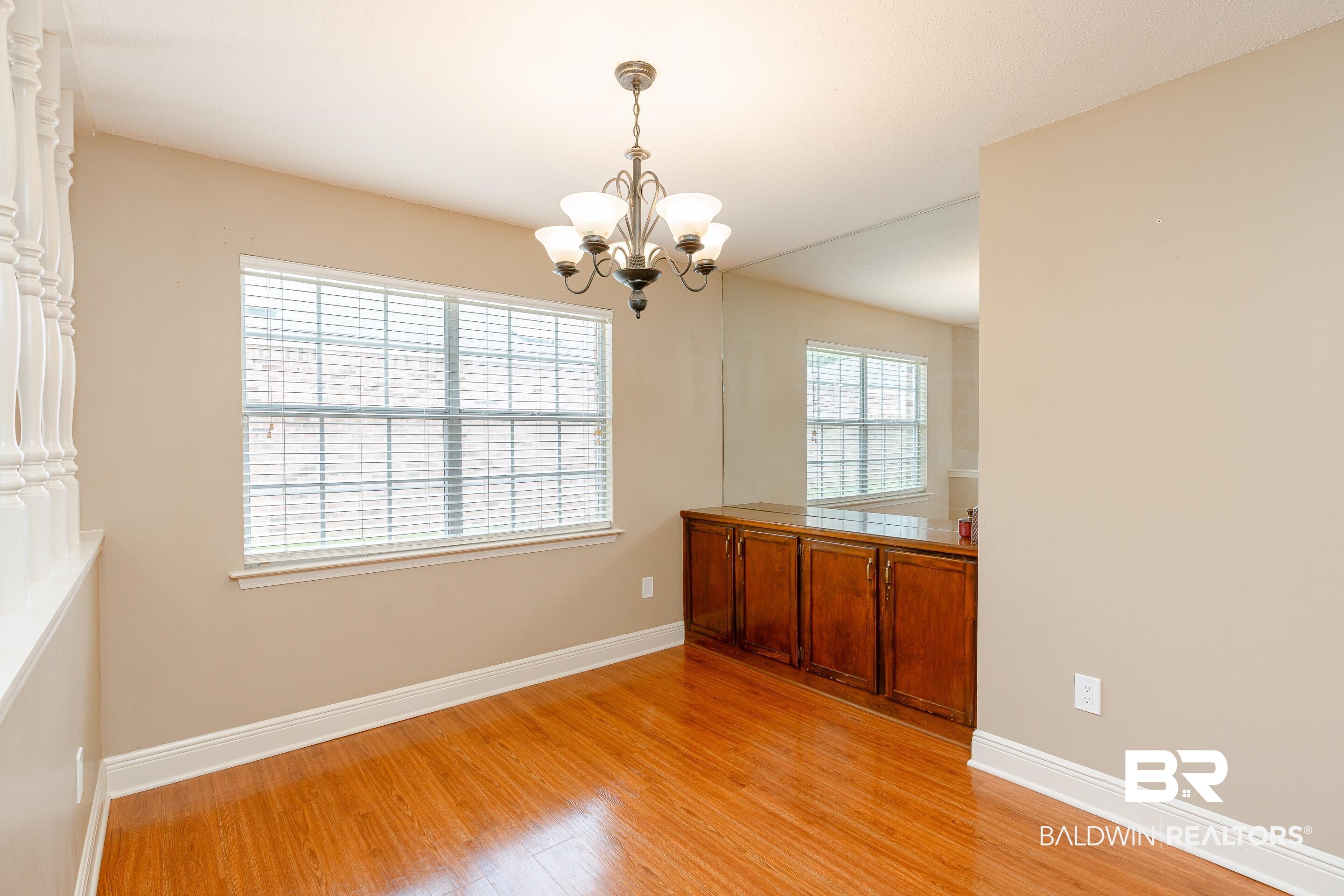 23 Old Mill Court Mobile, AL 36608 - Photo 9 of 37 Unfurnished dining area featuring a notable chandelier, light hardwood / wood-style flooring, and plenty of natural light