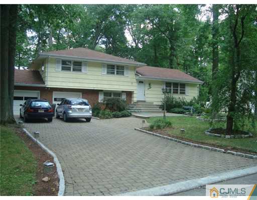 11 Huntington Road Edison, NJ 08820 - Photo 2 of 8 a front view of a house with a yard and garage