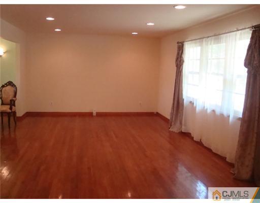 11 Huntington Road Edison, NJ 08820 - Photo 6 of 8 an empty room with wooden floor and windows