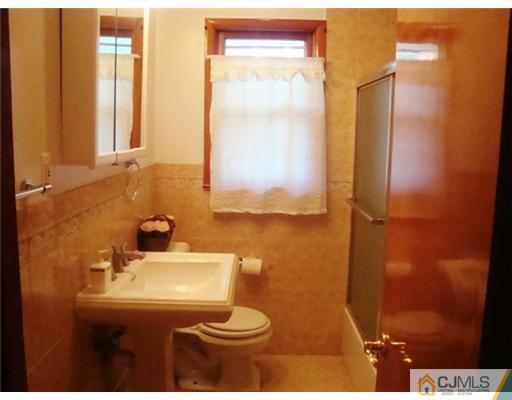 11 Huntington Road Edison, NJ 08820 - Photo 8 of 8 a bathroom with a sink a toilet and mirror