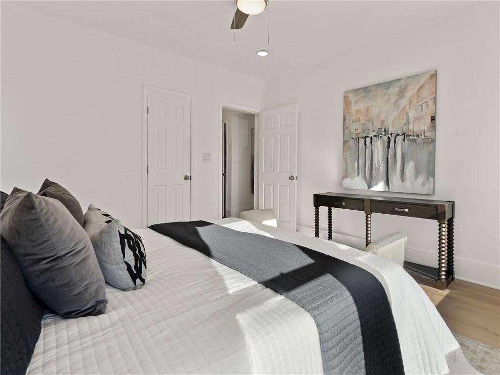 1639 Stokes Avenue Southwest Atlanta, GA 30310 - Photo 28 of 56 a bedroom with a bed and a chandelier