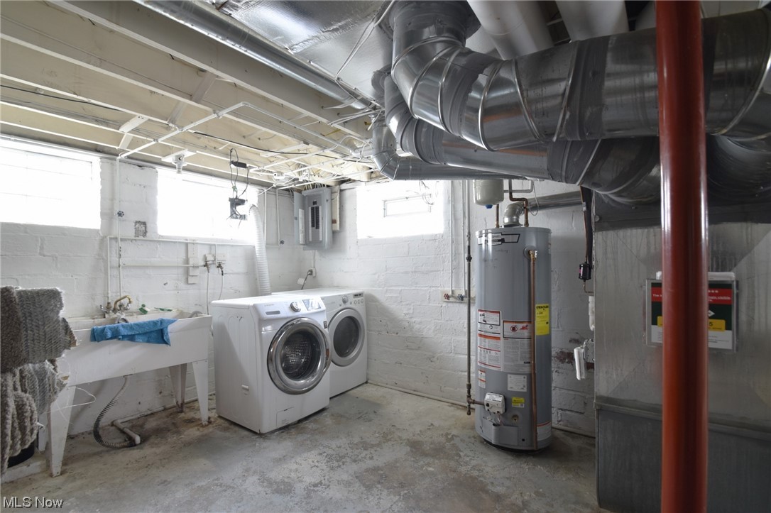 1135 Plainfield Road Cleveland, OH 44121 - Photo 30 of 32 Basement with sink, gas water heater, and washing machine and clothes dryer