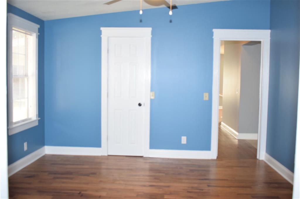 528 Juniper Creek Road Byron, GA 31008 - Photo 11 of 18 a view of an empty room with wooden floor and a window