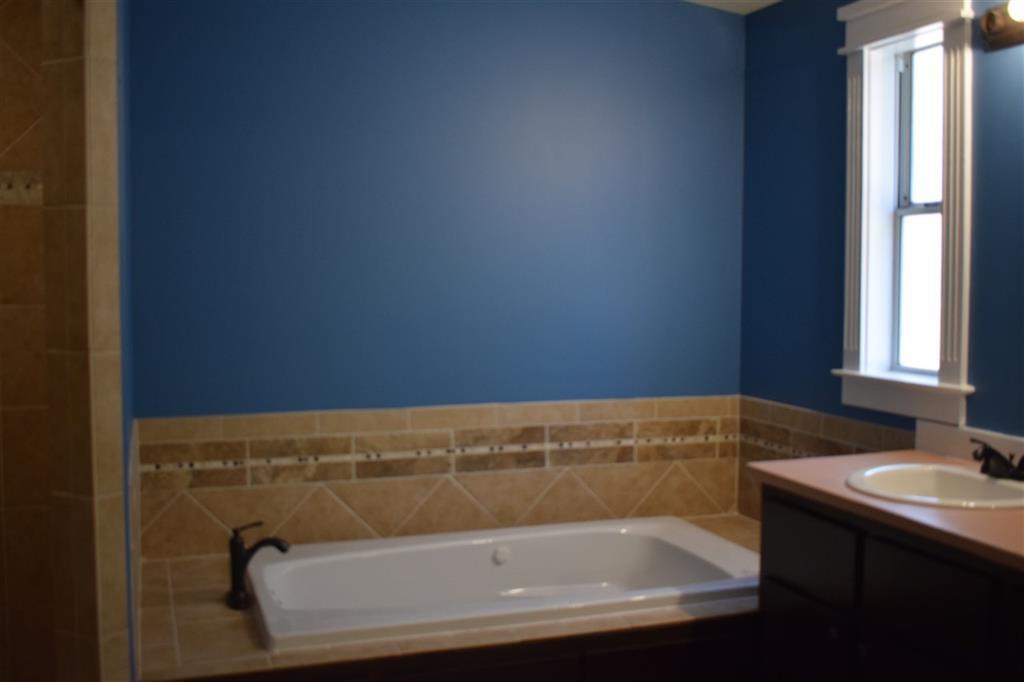 528 Juniper Creek Road Byron, GA 31008 - Photo 13 of 18 a bathroom with a granite countertop sink and a bathtub