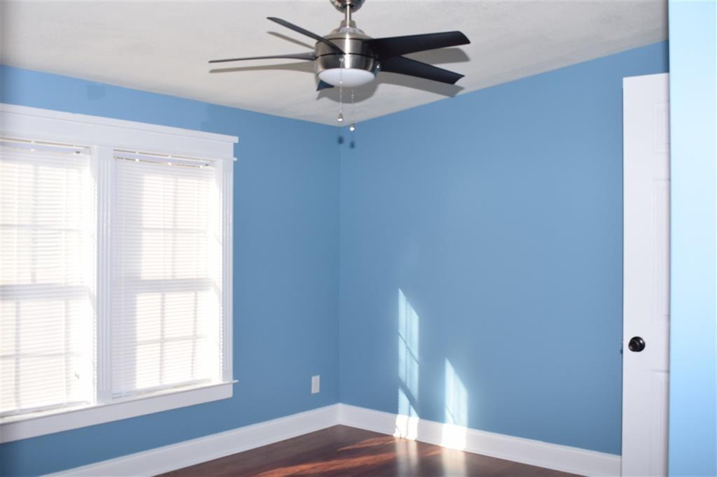 528 Juniper Creek Road Byron, GA 31008 - Photo 15 of 18 a view of empty room with wooden floor and fan