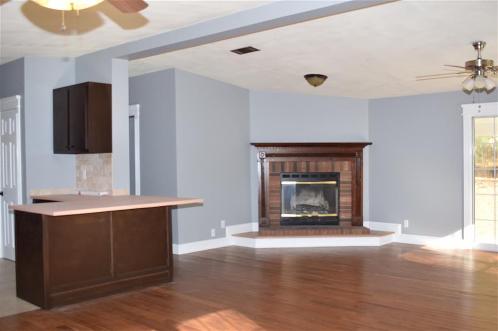 528 Juniper Creek Road Byron, GA 31008 - Photo 5 of 18 a living room with a fireplace furniture a rug and a window
