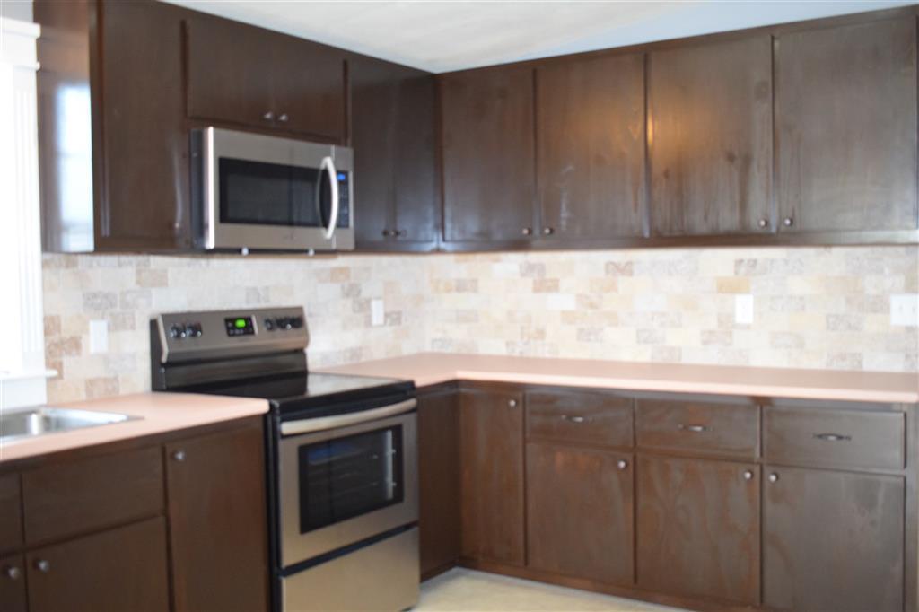 528 Juniper Creek Road Byron, GA 31008 - Photo 6 of 18 a kitchen with a sink and a microwave