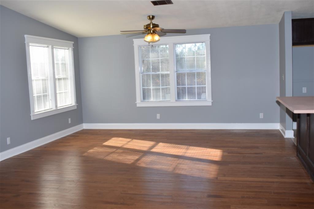 528 Juniper Creek Road Byron, GA 31008 - Photo 9 of 18 a view of empty room with wooden floor and fan