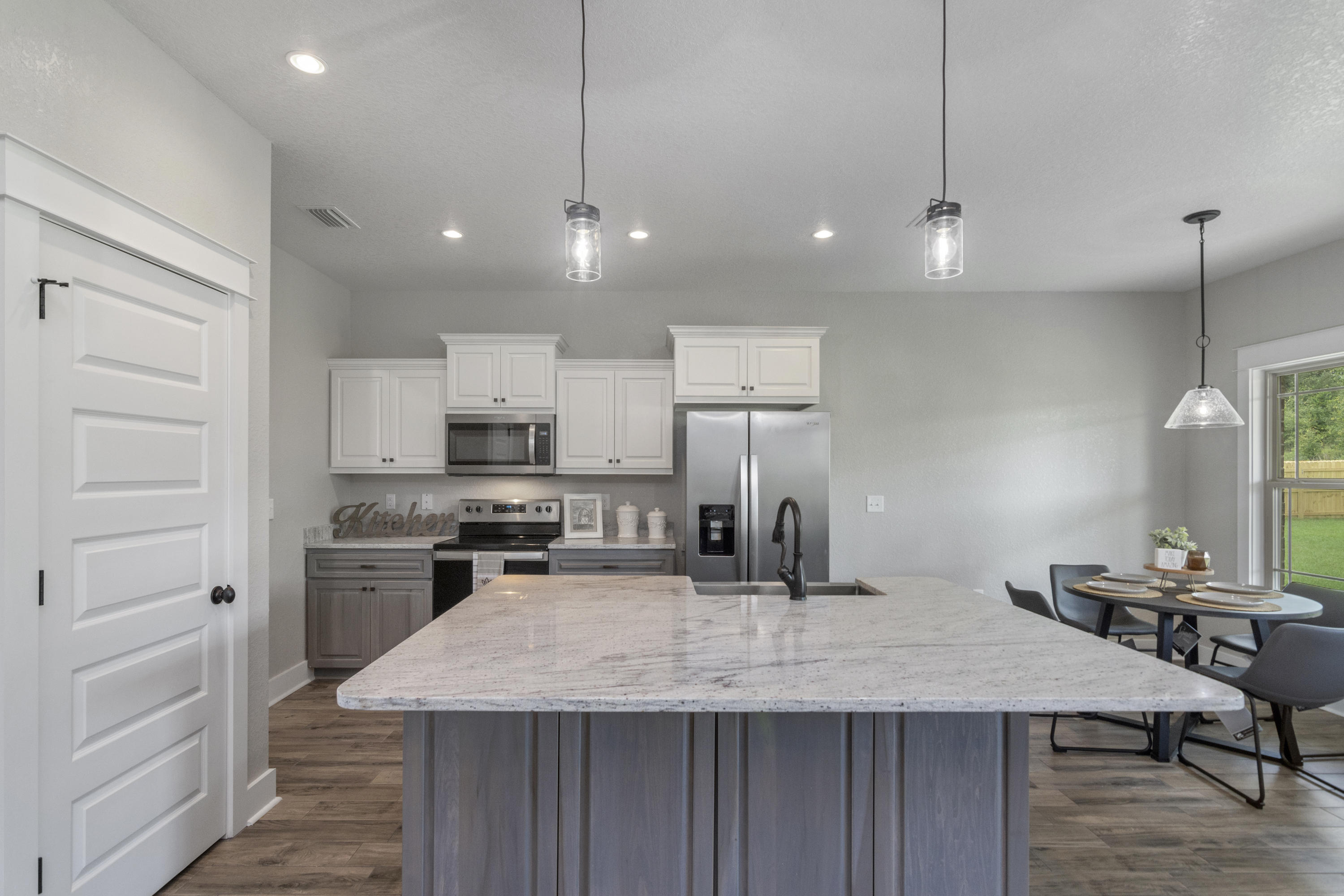 4079 Happy Trails Road Crestview, FL 32539 - Photo 7 of 27 a kitchen with kitchen island a counter space a sink stainless steel appliances and cabinets