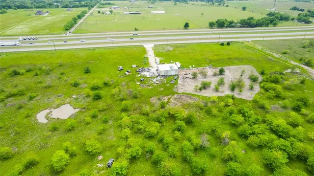 a swimming pool with lawn chairs and plants