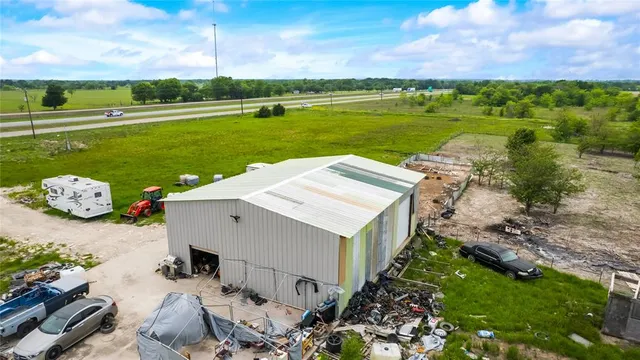 a view of a terrace with lawn chairs