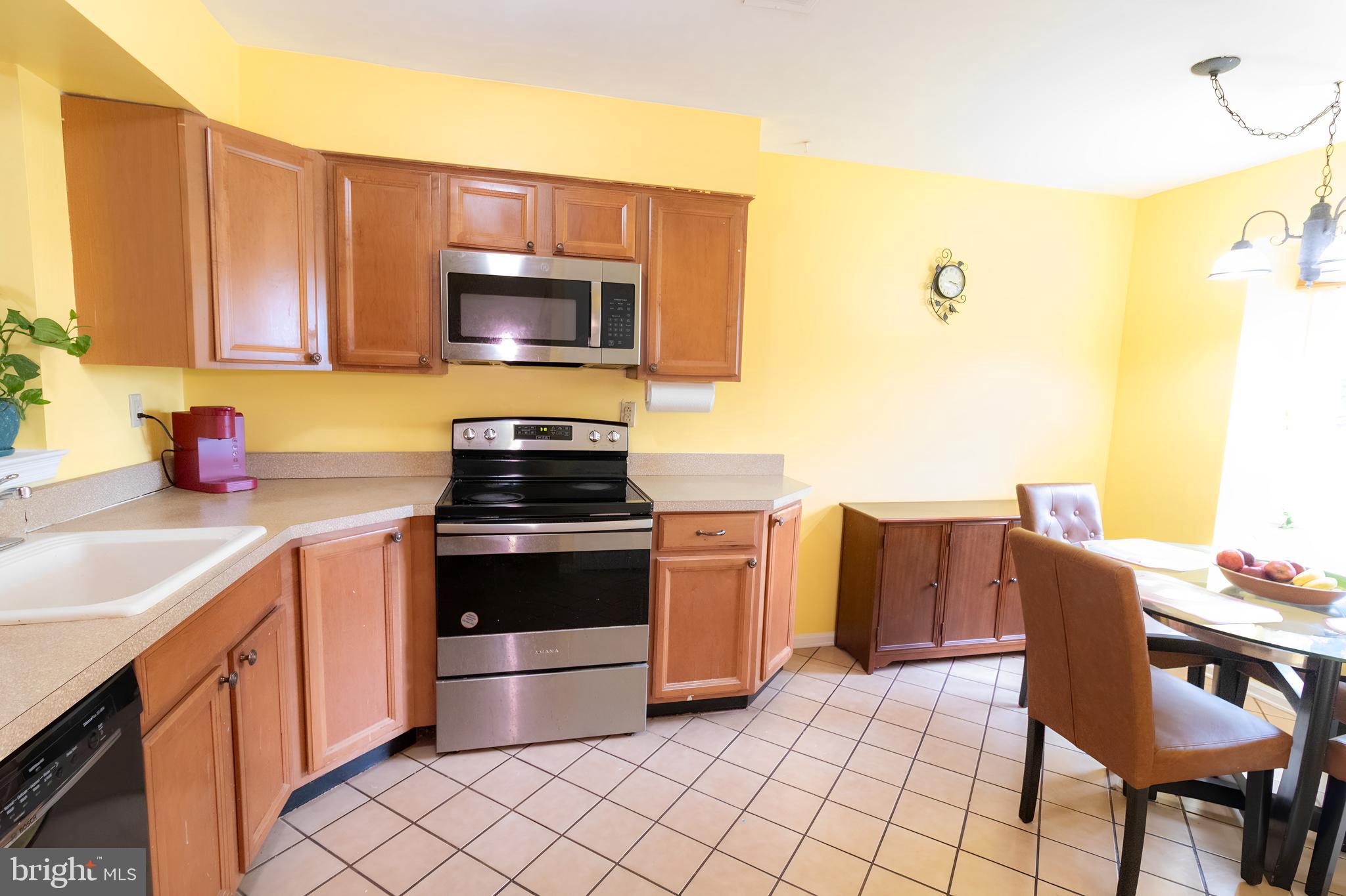 123 Caernarvon Court Exton, PA 19341 - Photo 2 of 26 a kitchen with stainless steel appliances a stove a sink and a microwave