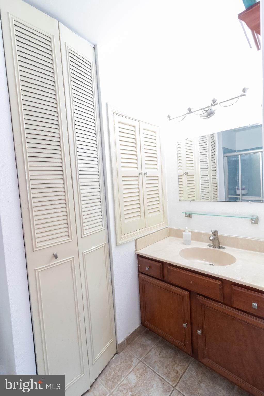 123 Caernarvon Court Exton, PA 19341 - Photo 21 of 26 a bathroom with a sink and a mirror