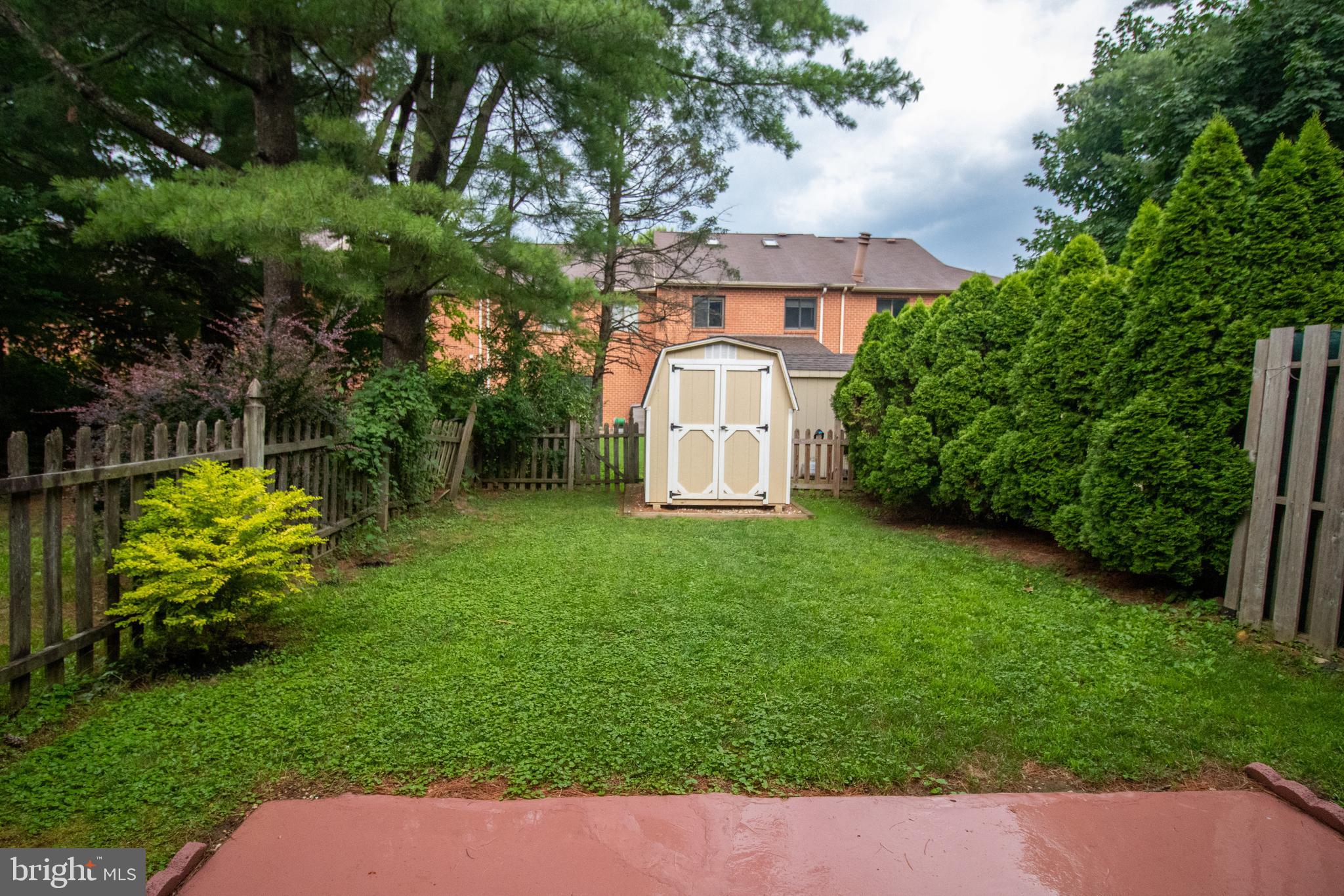 123 Caernarvon Court Exton, PA 19341 - Photo 25 of 26 a view of a garden with a bench in the garden