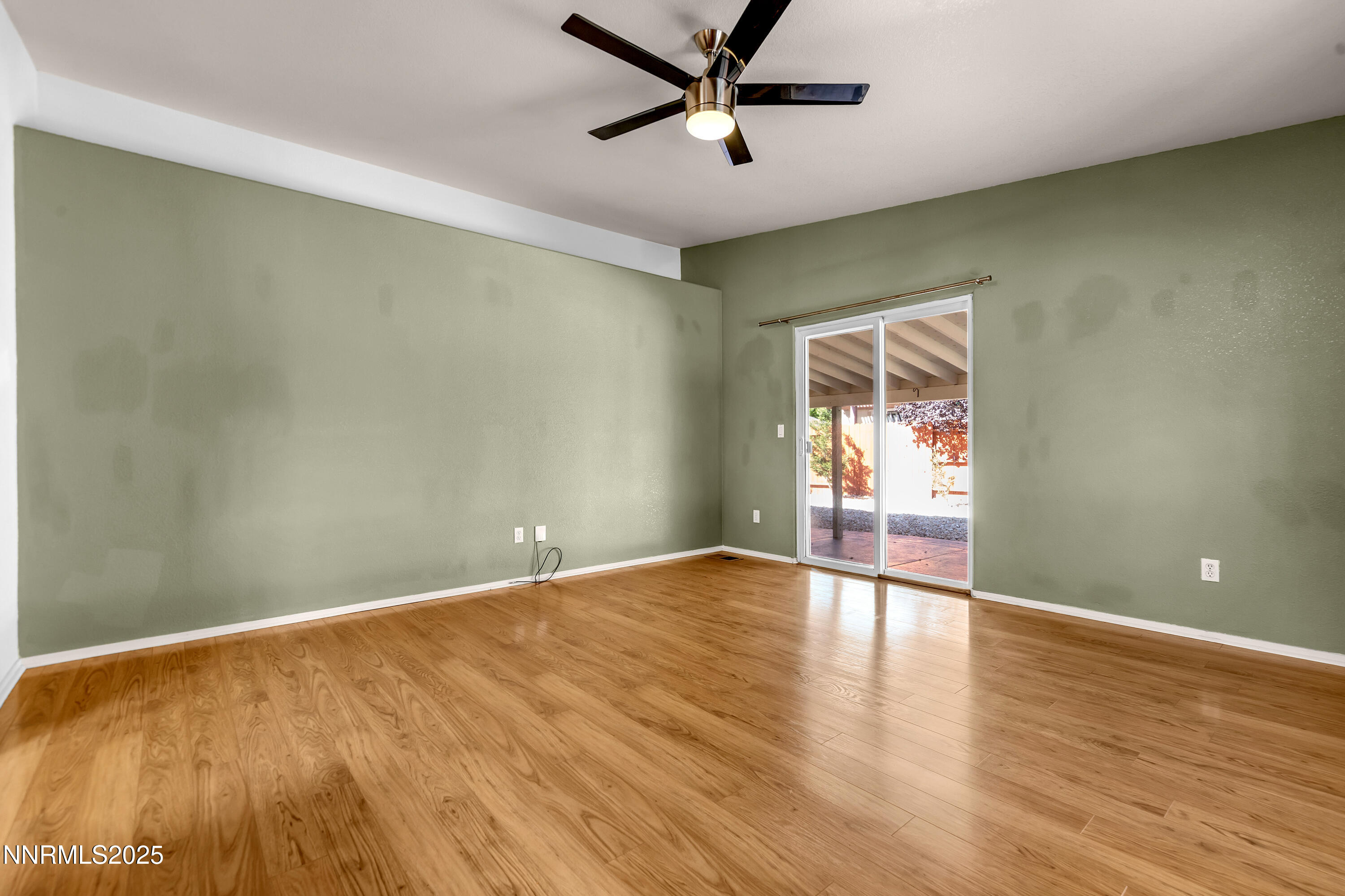 17507 Bear Lake Drive Reno, NV 89508 - Photo 14 of 42 an empty room with wooden floor and windows