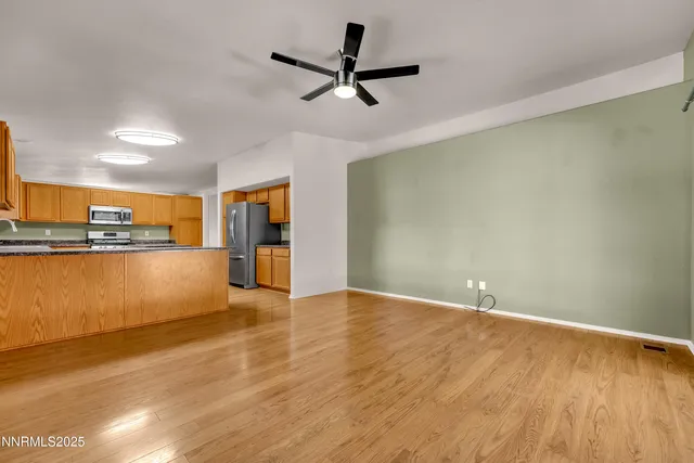 a view of a kitchen with a sink and a refrigerator