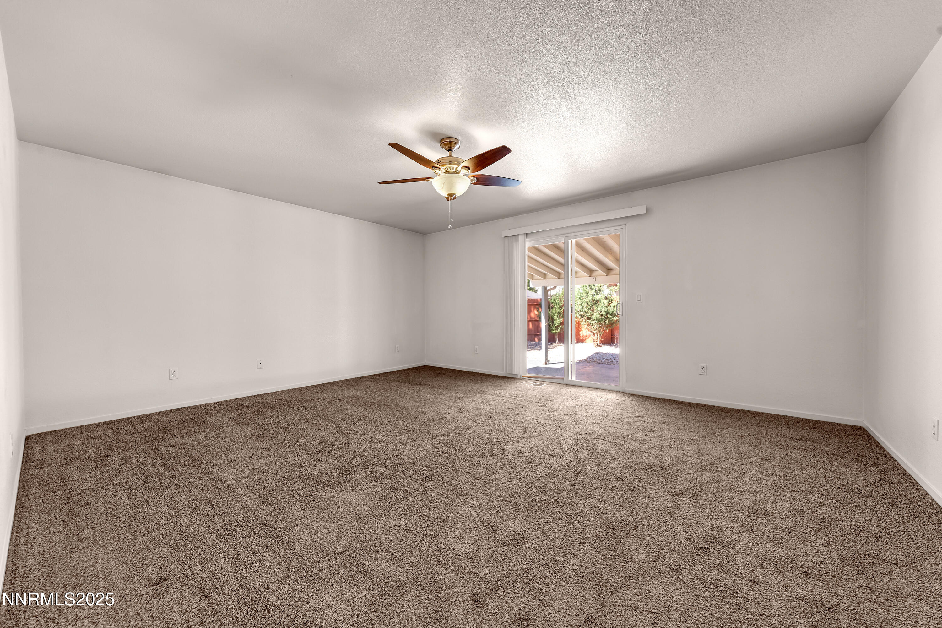 17507 Bear Lake Drive Reno, NV 89508 - Photo 23 of 42 an empty room with windows and ceiling fan