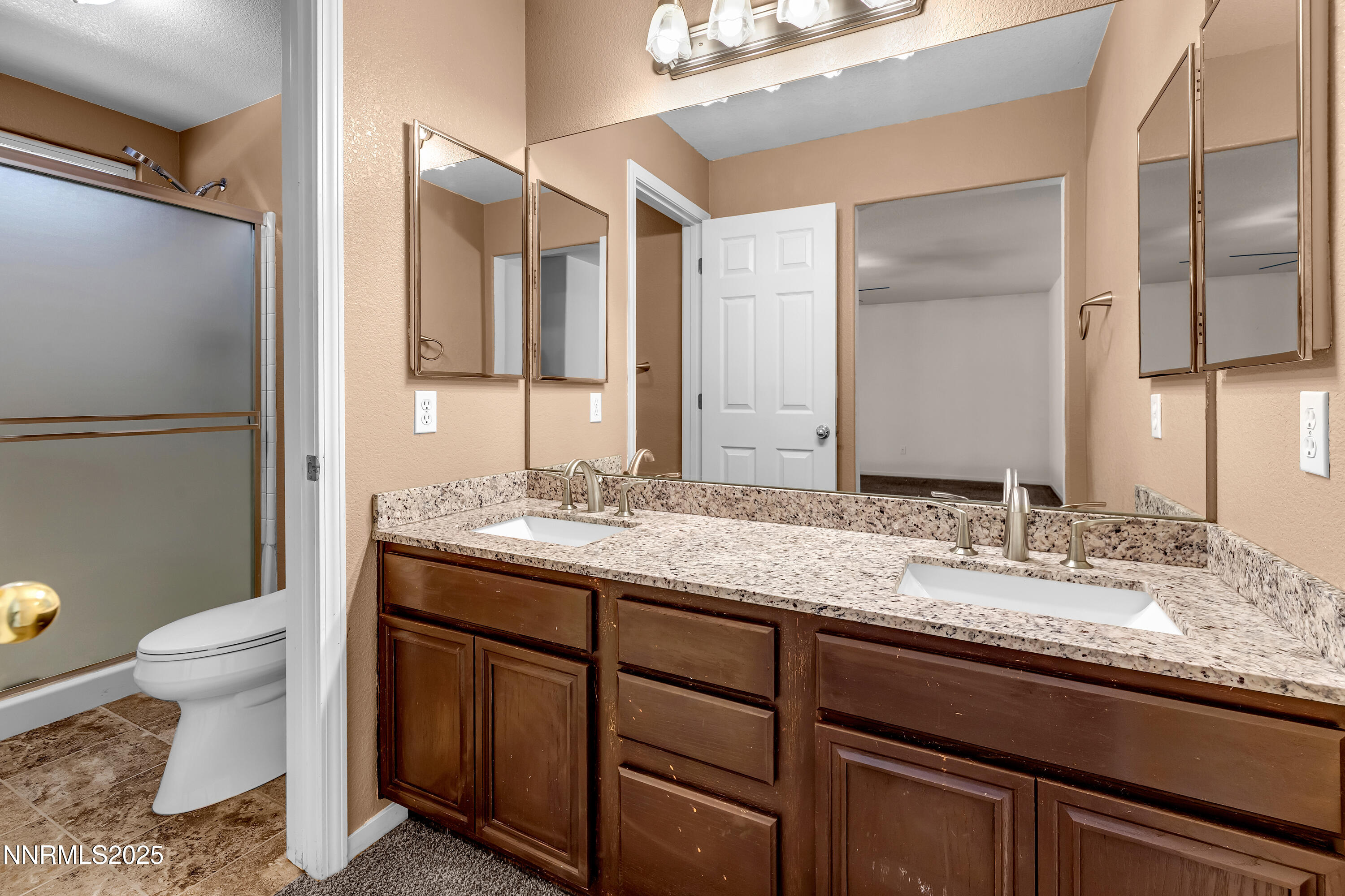 17507 Bear Lake Drive Reno, NV 89508 - Photo 24 of 42 a bathroom with a granite countertop sink and a mirror