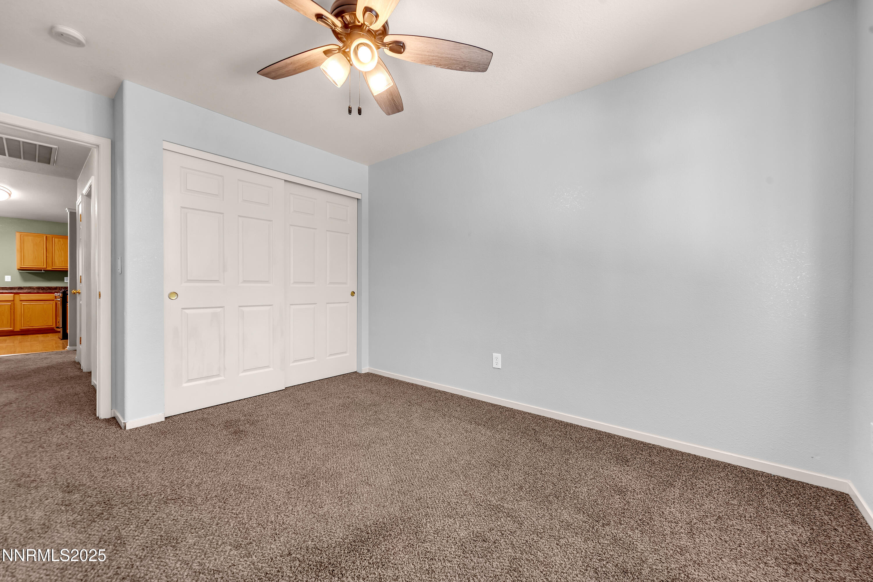 17507 Bear Lake Drive Reno, NV 89508 - Photo 30 of 42 an empty room with closet and a chandelier fan